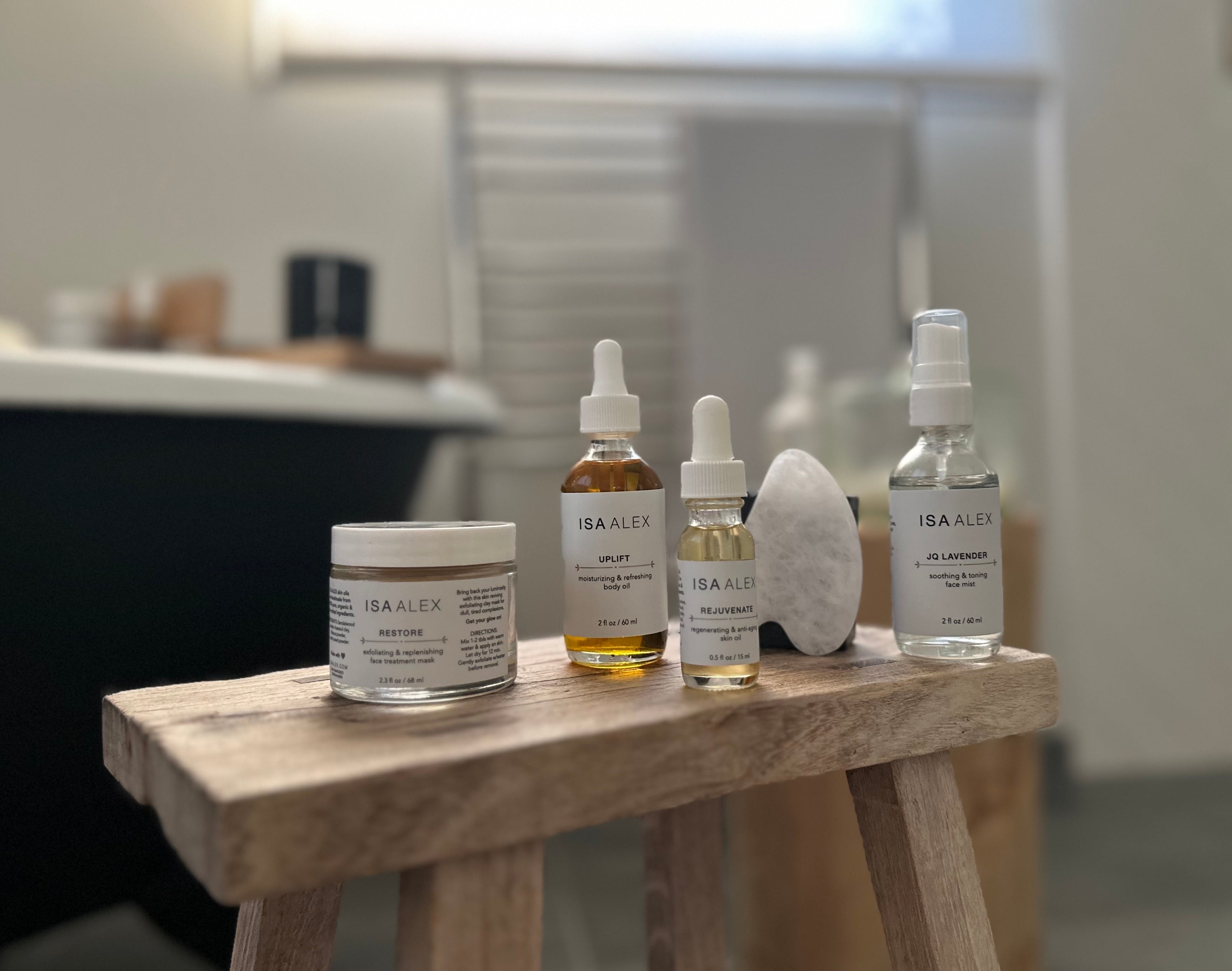 closeup of natural skincare products and face body oils on a wooden shelf in bathroom for a blog on busy women and natural skincare